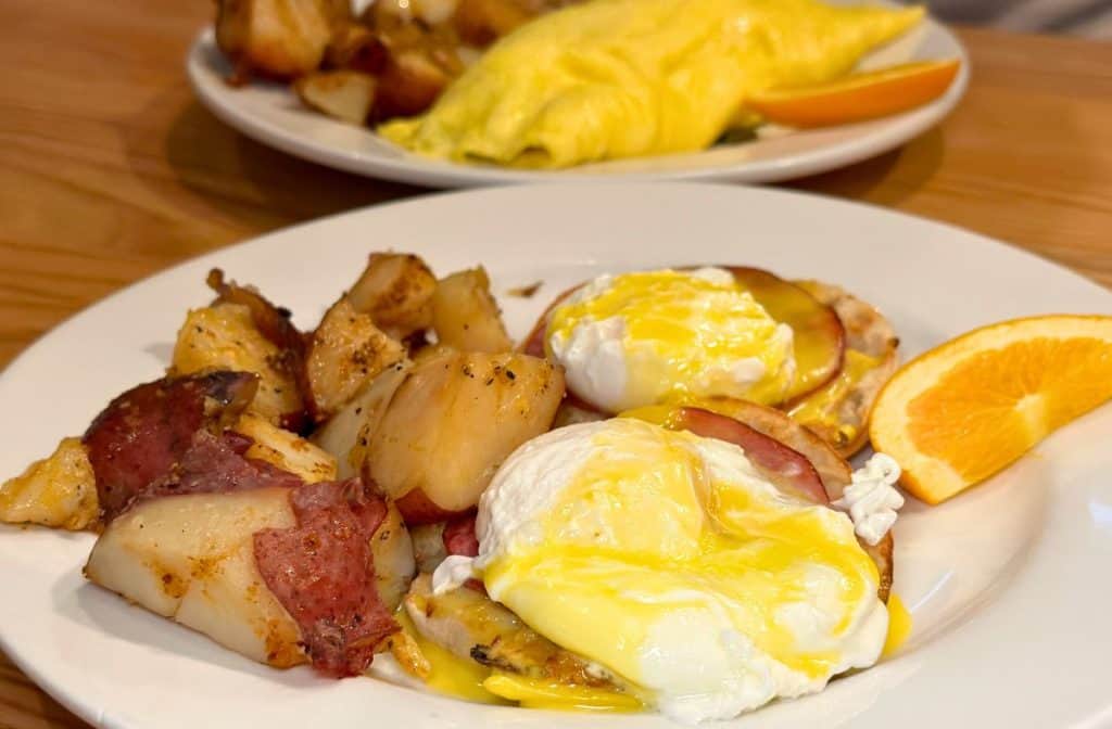 Eggs Benedict with a side of potatoes