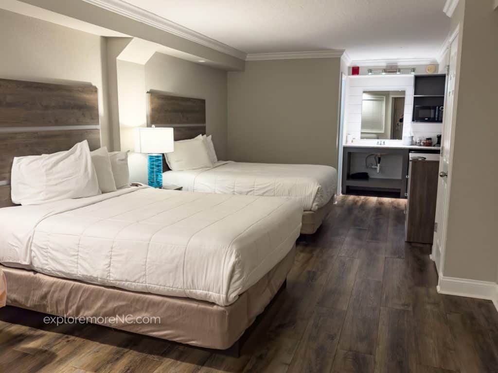 The Islander Hotel room with 2 queen beds, a kitchenette in the background