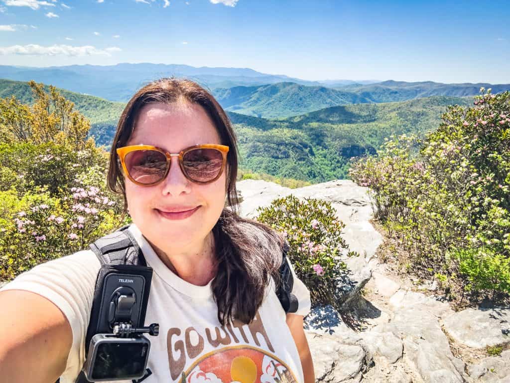 Sarah on top of Table Rock Summit wearing sunglasses