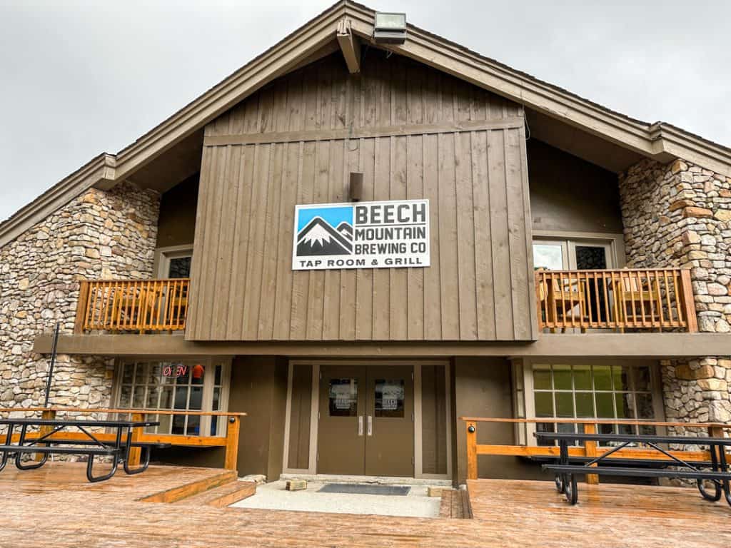 Exterior view of Beech Mountain Brewing Co Tap Room & Grill, featuring a rustic wood-and-stone facade.