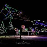 Holiday-themed airplane and tree light display at Shadrack’s Christmas Wonderland, creating a whimsical winter scene.