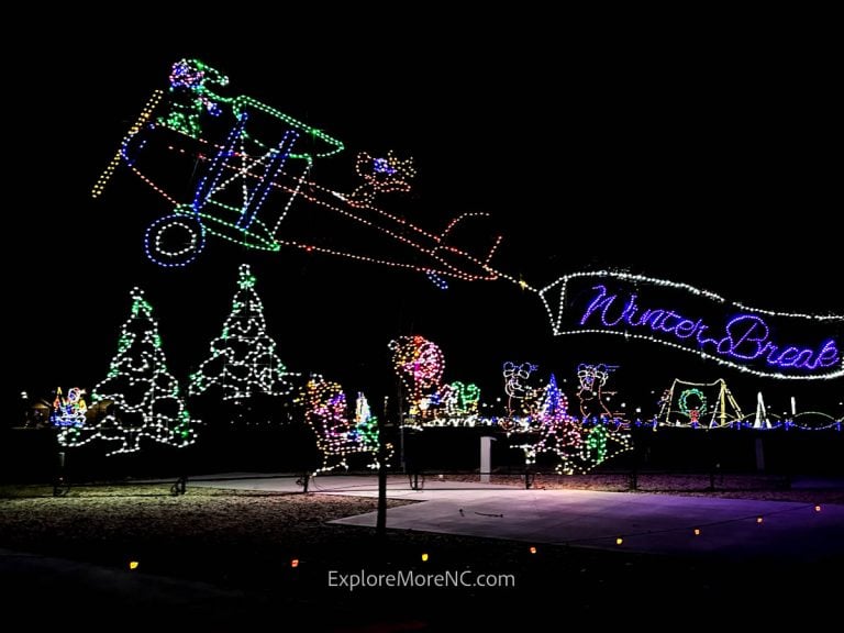 Holiday-themed airplane and tree light display at Shadrack’s Christmas Wonderland, creating a whimsical winter scene.