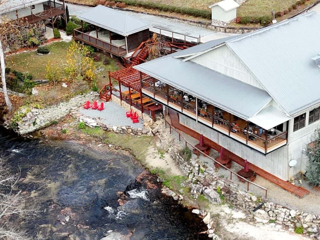 Scenic riverside dining at vineyard.